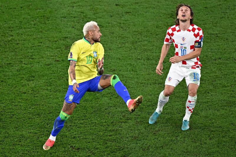 Neymar and Luka Modric eye the ball during the  World Cup quarter-final at Education City Stadium. Photograph: Anne-Christine Poujoulat/AFP via Getty Images
