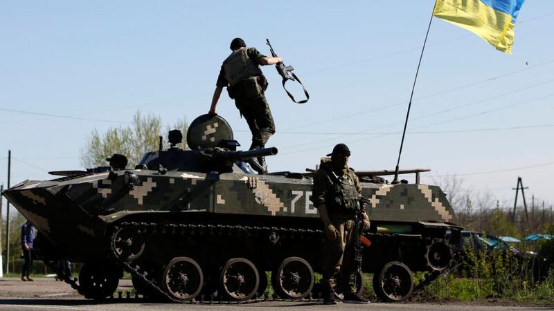 Ukrainian soldiers with an armoured personnel carrier at a checkpoint in the village of Malinivka, east of Slaviansk, eastern Ukraine, today.  Photograph: Marko Djuric/Reuters