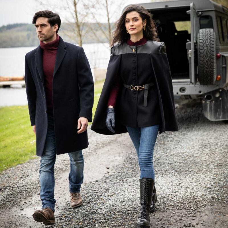 Left: Navy melton wool mid length coat (€315). Right:  Tailored cape jacket (€320), burgundy cable knit (€80)