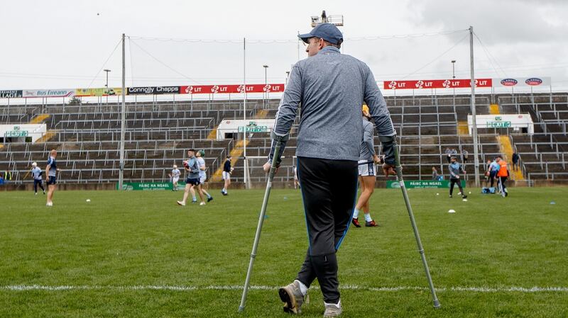 An injured Shane Dowling watches his Na Piarsaigh teammates warm-up ahead of the 2019 Limerick Senior final. Photograph: James Crombie/Inpho
