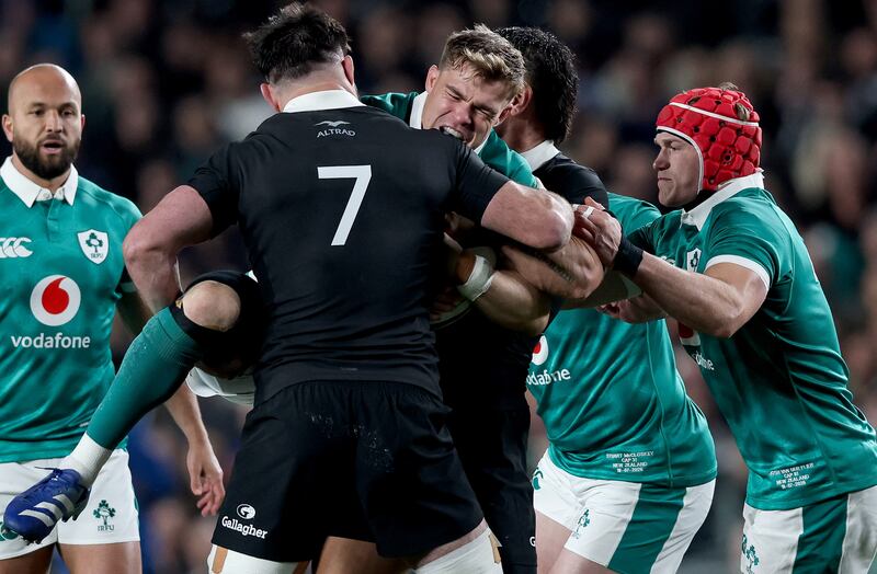   Ireland's Garry Ringrose is tackled by Luke Jacobson of New Zealand. Photograph: Billy Stickland/Inpho