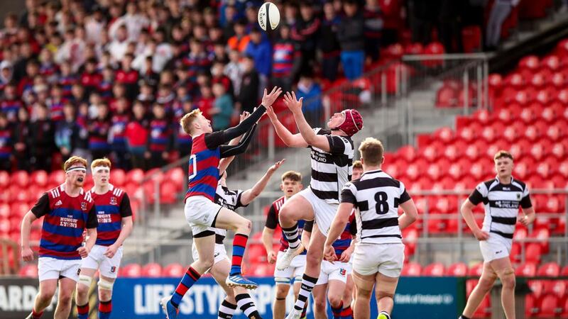 St. Munchin’s Alex Wood goes up for the ball with  Darragh McSweeney of PBC during the Clayton Hotels Munster Schools Senior Cup semi-final at Musgrave Park. Photograph: Tommy Dickson/Inpho