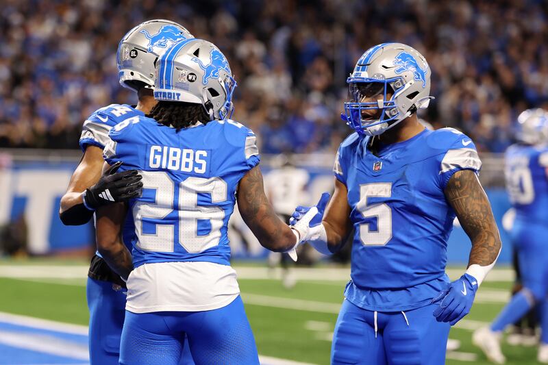 Jahmyr Gibbs of the Detroit Lions celebrates with David Montgomery and Amon-Ra St. Brown after scoring a touchdown in the second quarter of a game against the Jacksonville Jaguars. Photograph: Gregory Shamus/Getty Images