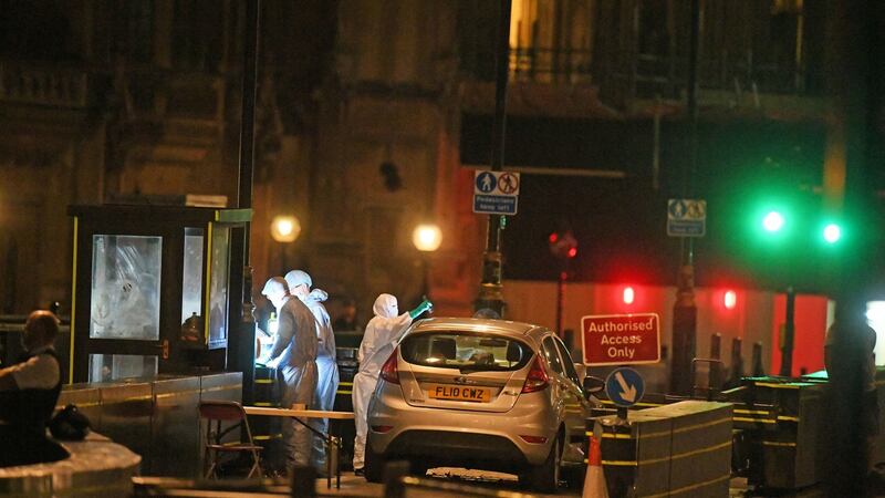 Forensic officers by the car that crashed into security barriers outside the Houses of Parliament in  Westminster, London, on Tuesday.  Photograph: Victoria Jones/PA Wire