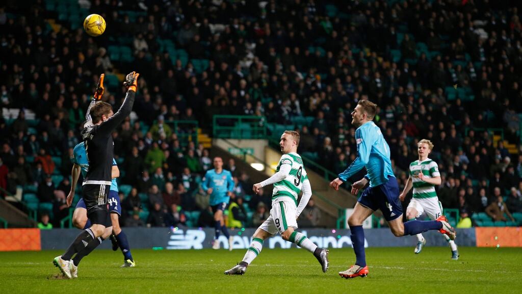 Celtic’s Leigh Griffiths lifts the ball over Hamilton goalkeeper Michael McGovern to score his side’s seventh goal and complete his hat-trick. Photograph: Lee Smith/Action Images via Reuters/Livepic