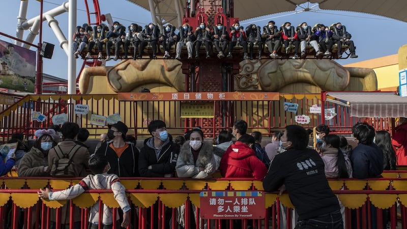 Patrons queue for a ride at the Happy Valley park in Wuhan on January 2nd. Photograph:  Gilles Sabrie/The NewYork Times