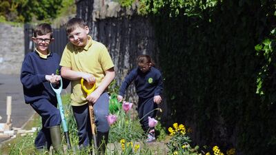 Paul Gore, 11, and Lee Weldon, 9, who attends Phoenix Park Specialist School,  in preparation for Ireland’s first nurture garden, which was designed for  Bloom  for children with specialist educational needs.  Photograph: Aidan Crawley