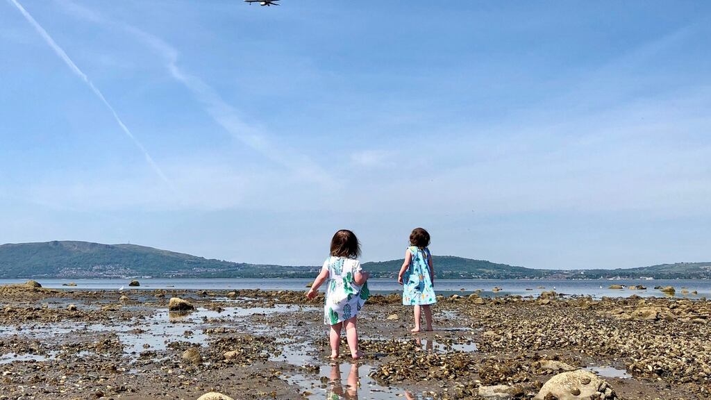 Children enjoy the warm weather at Seapark beach in Holywood, Co Down on Monday. Photograph: David Young/PA Wire