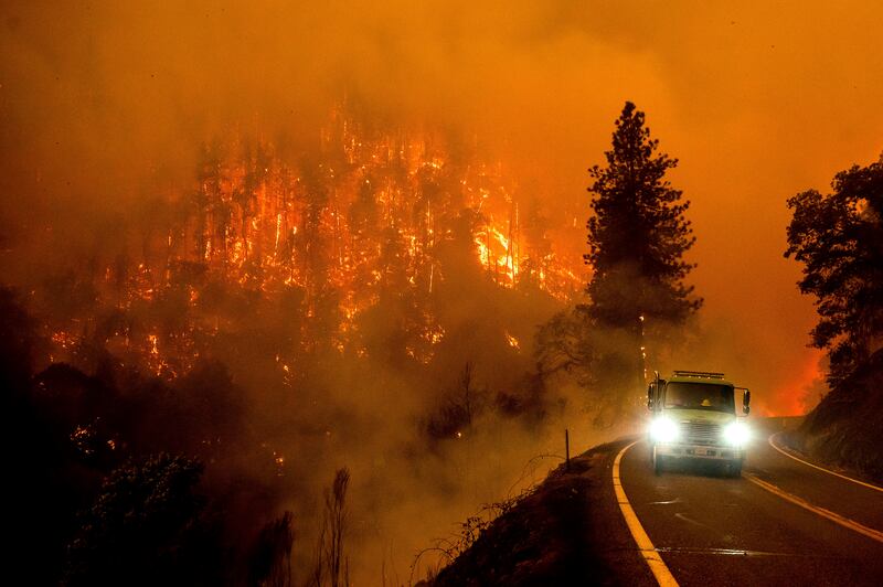 A firetruck drives along California Highway 96 as the McKinney fire burns in Klamath National Forest. Photograph: Noah Berger/AP