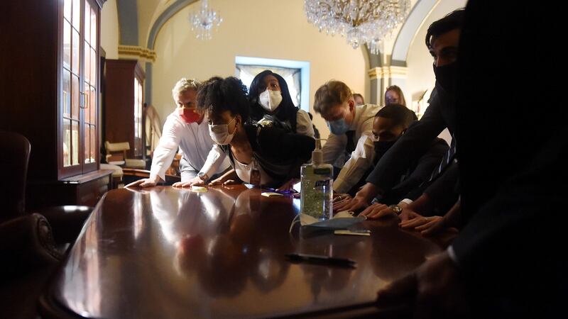 Congress staffers barricade themselves into a room in the US Capitol. Photograph:  Olivier Douliery/AFP via Getty Images