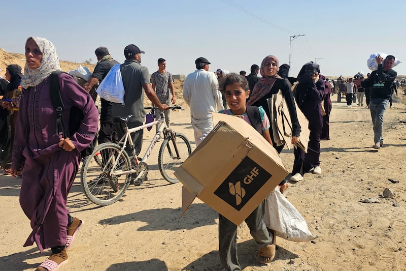 Displaced Palestinians walk to receive humanitarian aid packages from a US-backed foundation in Rafah in the southern Gaza Strip. Photograph: AFP via Getty Images
