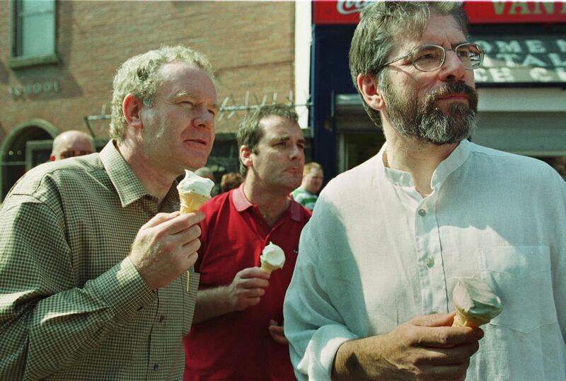 The Sinn Fein president Mr Gerry Adams and former Education Minister Mr Martin McGuinness enjoy an ice cream while watching yesterday's march in Belfast to commemorate the 19th anniversary of the Hunger Strikes in 2000.  Photograph: Frank Miller / The Irish Times