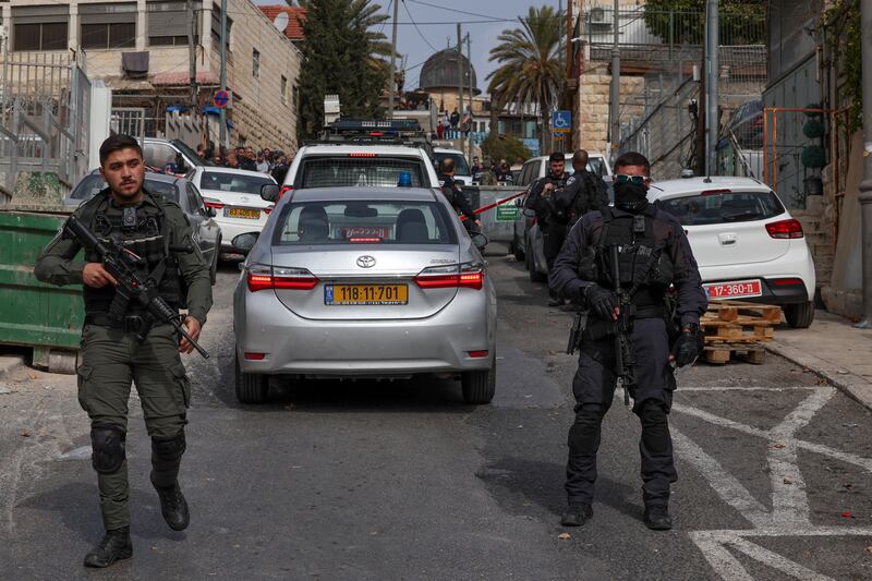 Israeli security forces and emergency service personnel gather at a cordoned-off area in the city amid increasing violence. Photograph: Ahmad Gharabali/AFP/Getty Images