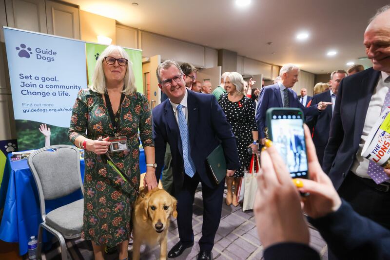 DUP leader Jeffrey Donaldson (second left) poses with guide dogs campaigner June Best with her guide dog Clyde, during his party's annual conference in Belfast. Photograph: Liam McBurney/PA Wire
