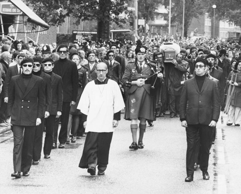 The funeral procession of Irish armed robber, Michael Gaughan, who died in Parkhurst Prison after a 65 day hunger strike. His coffin is preceded by a piper and flanked by members of the Irish Republican army as it is carried through the streets of Kilburn. (Photo by Â© Hulton-Deutsch Collection/CORBIS/Corbis via Getty Images)