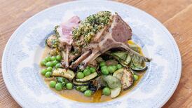 Herb-crusted lamb rack with courgettes, peas and a light butter sauce