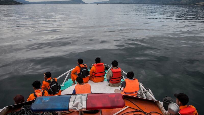 Rescue team members search for missing passengers on Lake Toba in the province of North Sumatra on Wednesday. Photograph: Ivan Daman/AFP/Getty Images