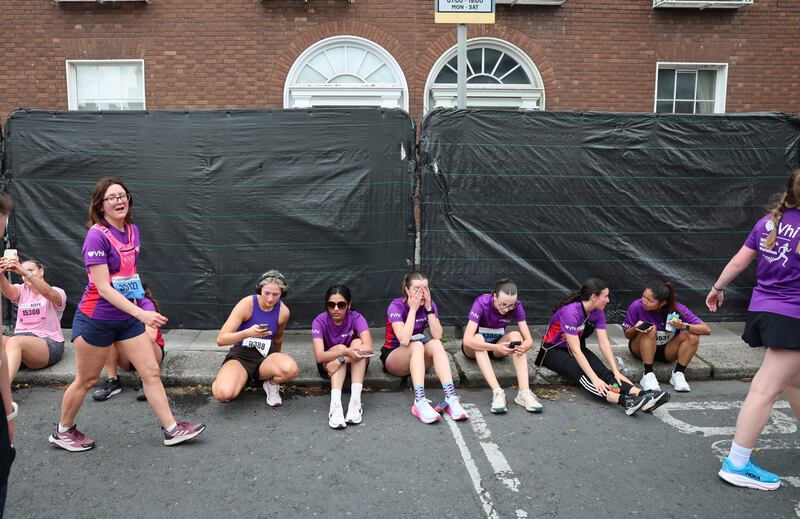 Participants take a well earned break after the Vhi Womens Mini Marathon.
Photograph: Dara Mac Dónaill / The Irish Times
