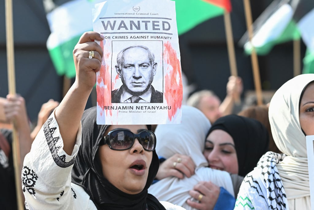 A woman holds up a "Wanted" poster featuring Israel's Prime Minister Binjamin Netanyahu as they take part in a 'Solidarity with Palestine' demo in Berlin on August 9, 2025. Photo: Ralf Hirschberger/AFP via Getty Images)