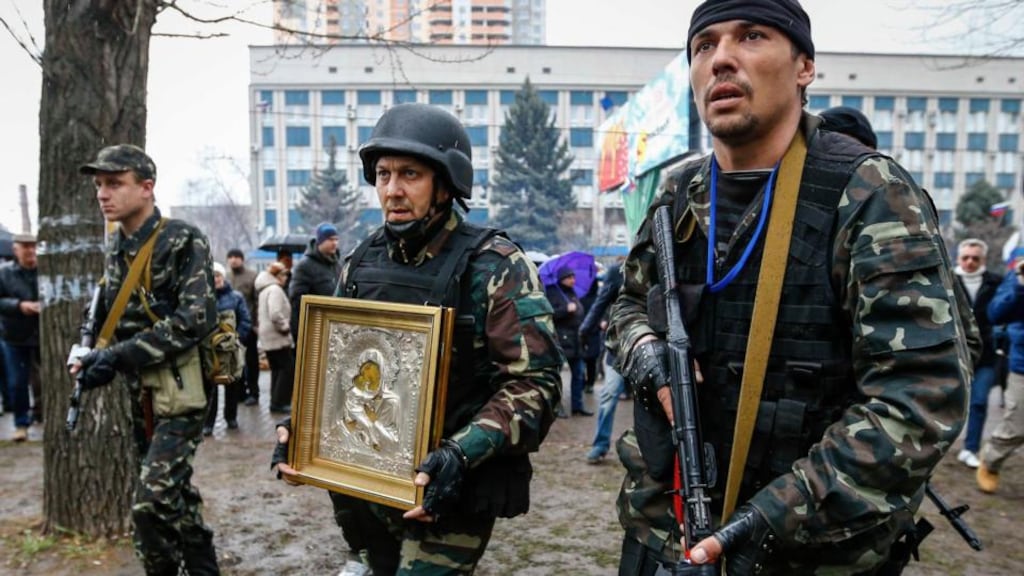 Pro-Russian protesters, one carrying an icon allegedly found in seized state security service office in Luhansk. The icon was given to nearest Orthodox church. Photograph: Reuters/Shamil Zhumatov