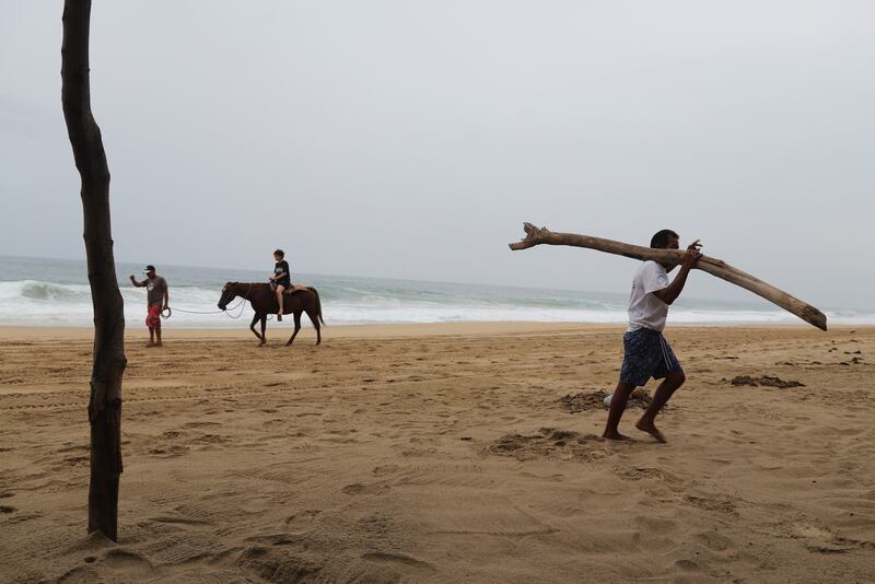 Tourists were driven from the beach in Acapulco as rain began to pelt the resort and winds picked up. Photograph: Bernardino Hernandez/AP