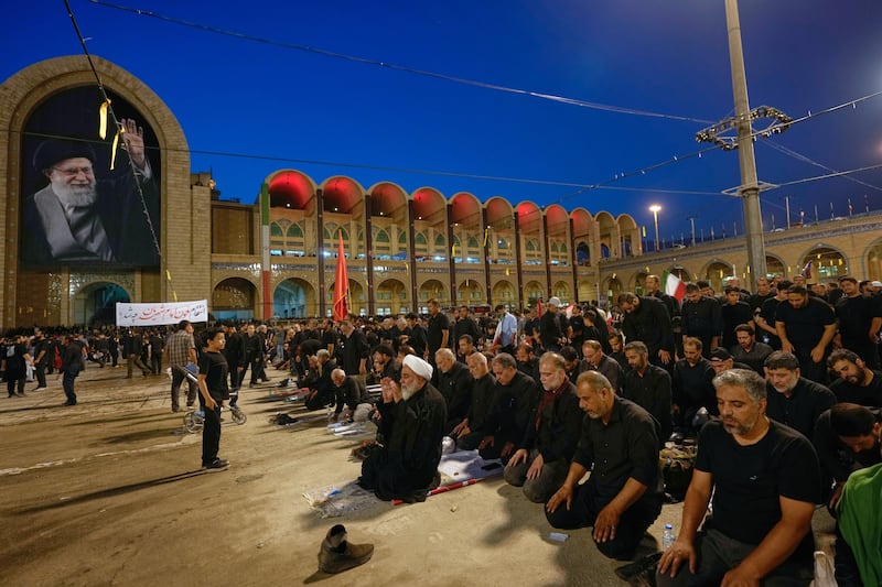 A cleric leads a prayer during the funeral ceremonies for slain Iranian supreme leader Ayatollah Ali Khamenei and members of his family. Photograph: Altaf Qadri/AP