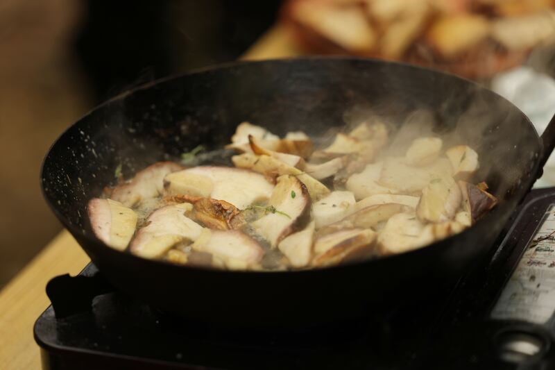 Hungry foragers sample the freshly cooked mushrooms served simply with bread. Photograph: Alan Betson