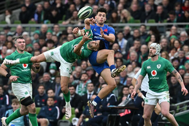 Ireland scrumhalf Conor Murray challenges in the air with France wing Ethan Dumortier. Photograph:Paul Ellis/AFP via Getty Images
