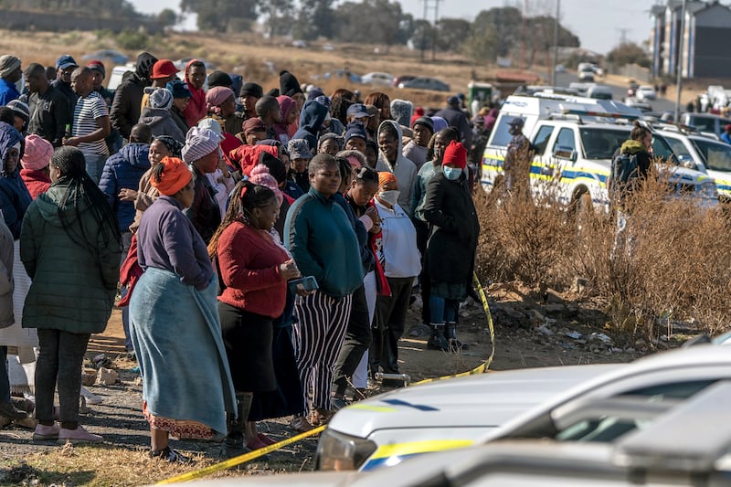 People gather at the scene of the shooting in Soweto, South Africa Photograph: Shiraaz Mohamed/AP