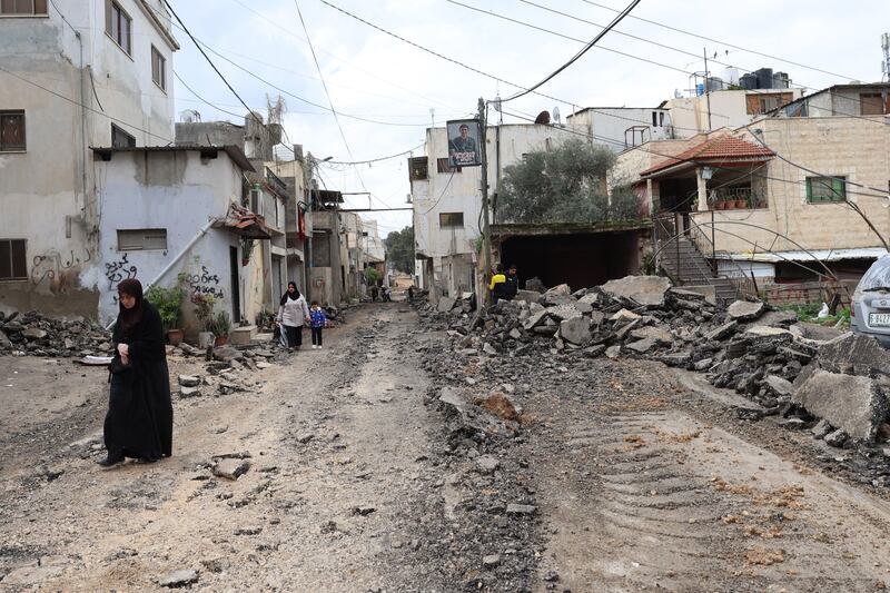 Palestinians walk along a damaged street at the Jenin refugee camp following an overnight Israeli raid on Thursday. Photograph: Alaa Badarneh/EPA