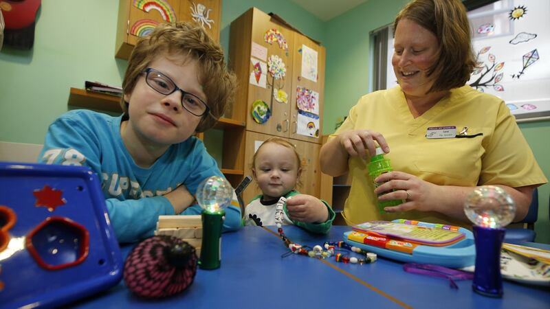 Play specialist Carol O’Connor with Tom (9) brother of patient Henry (centre) at Our Lady’s Children’s Hospital, Crumlin. Photograph: Nick Bradshaw