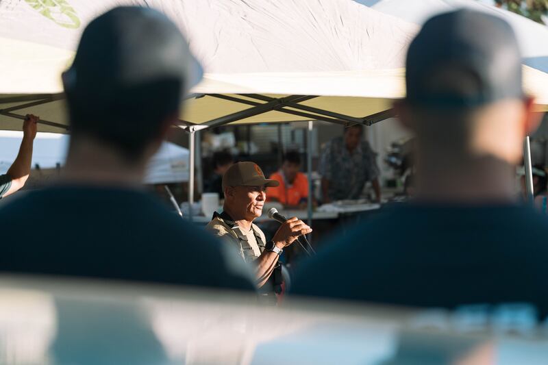 Archie Kalepa, a former head of Maui County’s ocean safety division, addresses a gathering of neighbours and volunteers at his home near the edge of the fire zone to organise donations. Photograph: Michelle Mishina Kunz/New York Times
                      