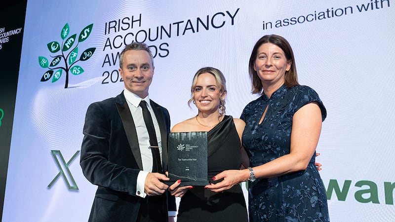 Cliona Doyle, managing director, Search4Less, presents the tax team of the year award to Teresa Campbell and Malachy McLernon, AAB