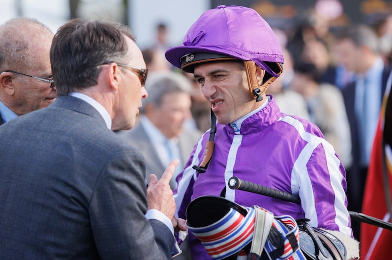 Aidan O'Brien briefs jockey Christophe Soumillon in advance of the Royal Bahrain Irish Champion Stakes at Leopardstown. Photograph: Inpho