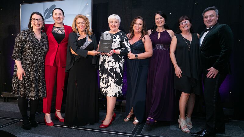 Denise McMorrow, Awards Judge, presents the Overall Excellence Award to the University College Cork team.