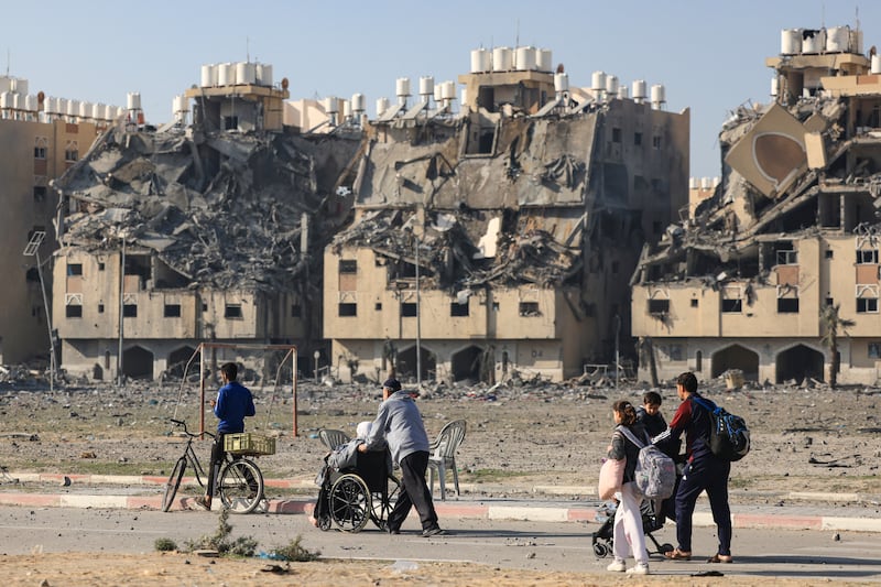Residents of a residential complex in Khan Younis carry some of their belongings as they flee their homes after an Israeli strike on Saturday. Photograph: Mahmud Hams/AFP via Getty Images