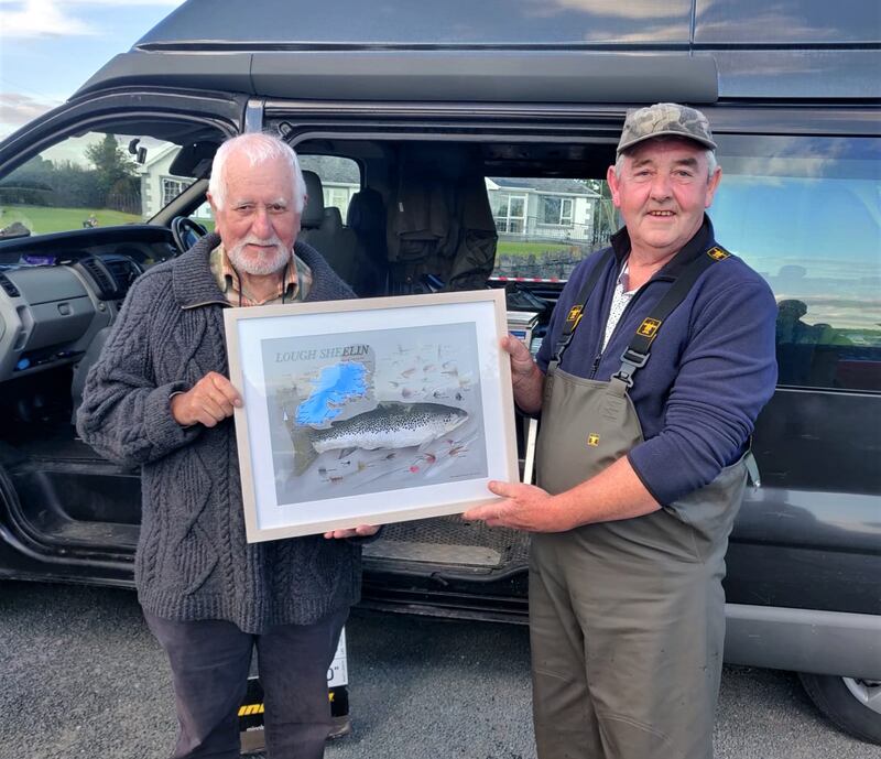Ned  Clinton (right), winner of the McDonald Cup last weekend on Lough Sheelin, with a trout of 4.112lb, receiving a framed print of the lake  from artist Liam O'Broin