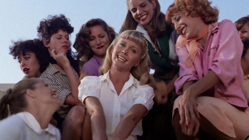 Olivia Newton-John:  Sandy is the outsider who comes in