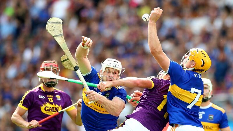 Tipperary’s Pádraic Maher and Ronan Maher battle with Wexford’s Conor McDonald. In the second half the Tipp half-back line, which also included Brendan Maher, became a wall.  Photograph: James Crombie/Inpho