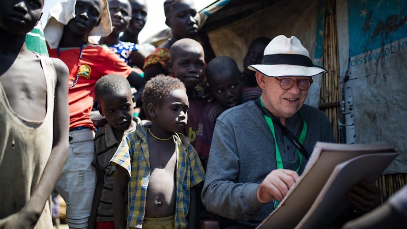 Irish artist Brian Maguire sketches a young boy in the PoC camp in Bentiu, South Sudan. Photograph: Steve De Neef/Concern Worldwide