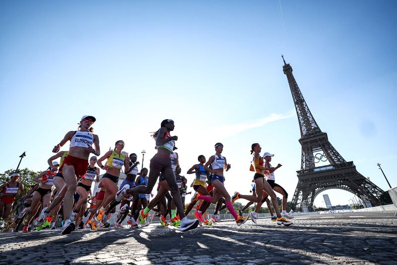 Olympians run past the Eiffel Tower during the women's marathon. Photograph: Anne-Christine Poujoulat/AFP via Getty Images