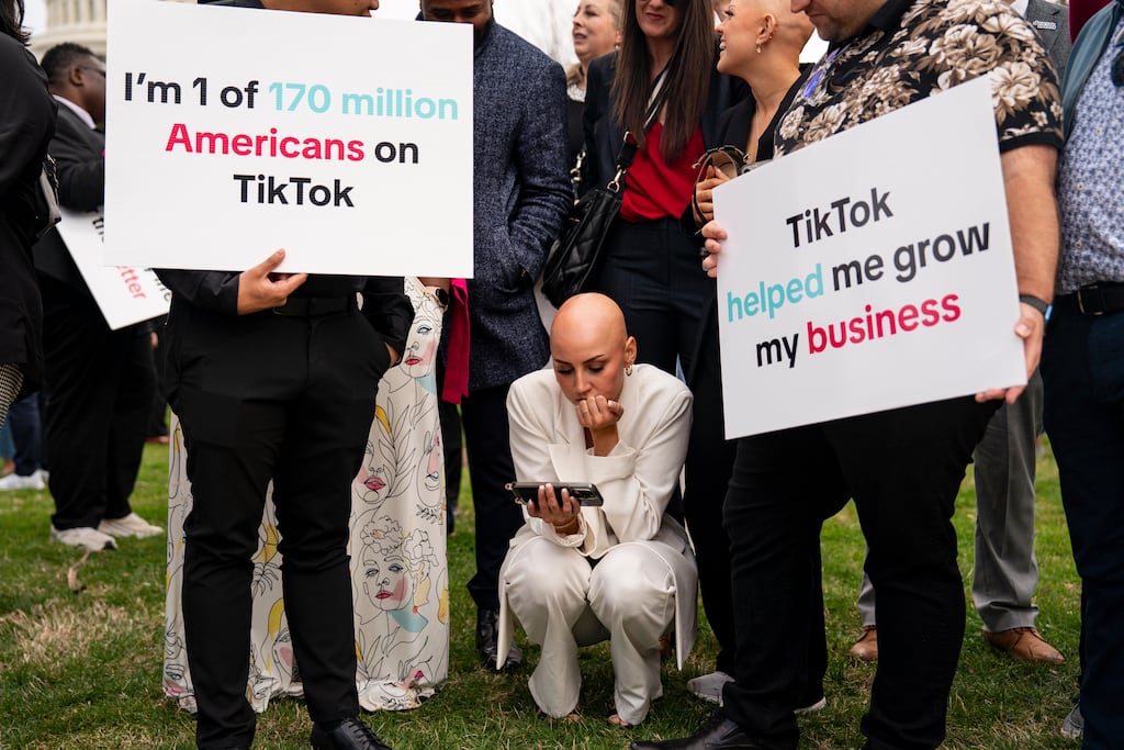 TikTok supporters watch a feed of a US vote on its future use outside the Capitol in Washington. Photograph: The New York Times