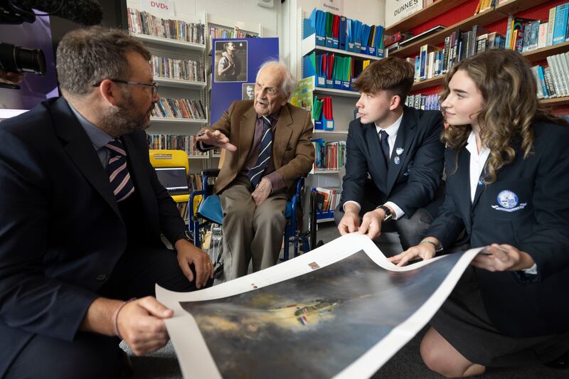 John Hemingway presents a print of his Hurricane aircraft on a visit to his old school, received by acting principal Rob Micallef (left), head boy Hugh Brownlee and head girl Amelia Flanagan. Photograph: Alan Betson

