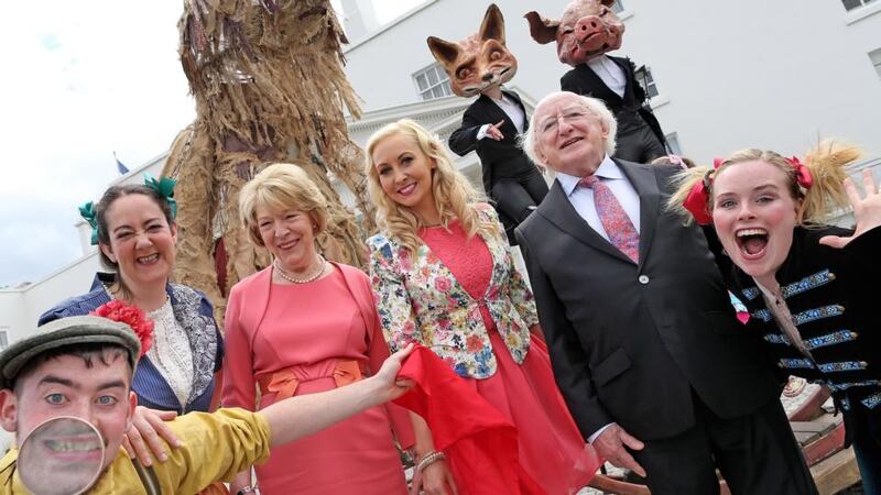 President Michael D Higgins and his wife Sabina with Emma O ‘Driscoll join Macnas outside the Áras  in the Phoenix Park for the first of the summer garden parties. Photograph: Maxwells/Julien Behal