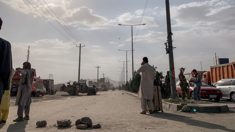 People gather near Kabul  airport. Photograph: Jim Huylebroek/The New York Times