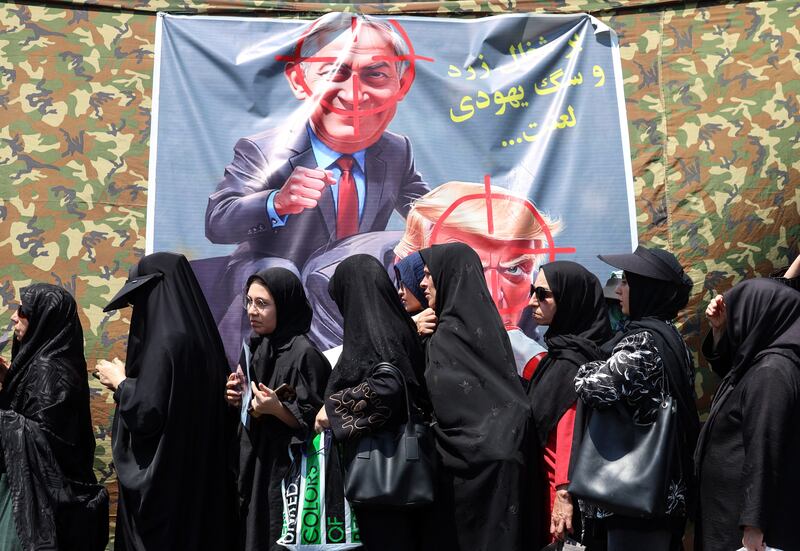 Shia Muslim devotees walk past a banner calling for revenge against US president Donald Trump and Israeli prime minister Binyamin Netanyahu during a mourning procession in Tehran on August 4th. Photograph: AFP via Getty Images