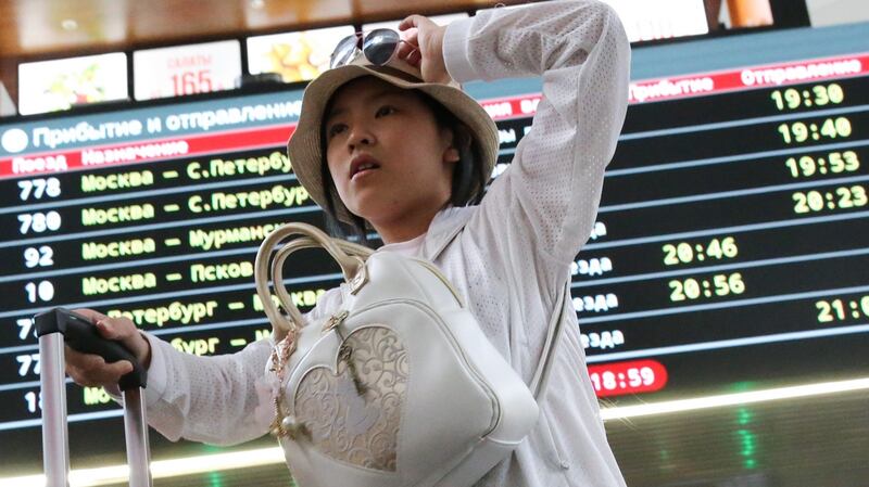 A young Chinese tourist in Moscow at  Leningradsky Railway Station.  File photograph: Anton Novoderezhkin/Tass/Getty Images)