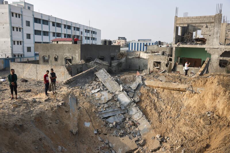 People stand around a crater following Israeli strikes on Rafah in the southern Gaza Strip on October 24th, 2023, amid ongoing battles between Israel and the Palestinian group Hamas. Photograph: Getty Images