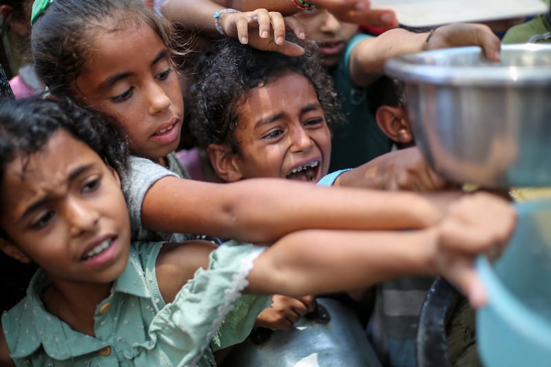 Palestinian children line up to receive a hot meal at a food distribution point in Nuseirat, Gaza Strip, on Monday, June 30th, 2025. Photograph: Eyad Baba/AFP/Getty
