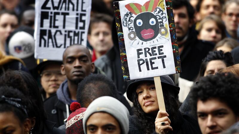 Demonstrators hold signs reading ‘Black Pete is Rascism’ and ‘Free Black Pete’ during a protest against Zwarte Piet (Black Pete) in Amsterdam in 2013. Photograph: Bas Czerwinski/AFP/Getty Images
